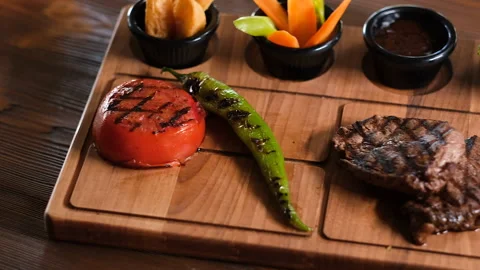 Presenting well-cooked steak, with veggies and sides, fa01 Stock Footage 277891065