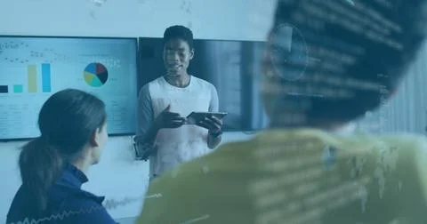 Presenting woman in light top explaining data in office, with tablet, charts and Stock Photos