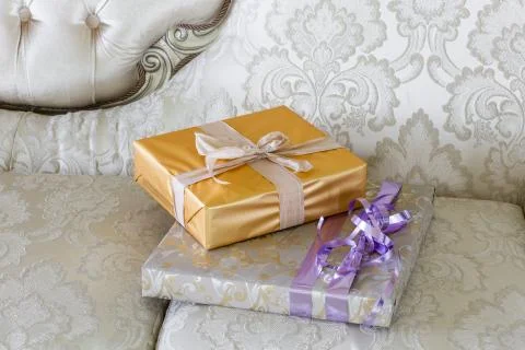Presents and Gift boxes on sofa. boxes with ribbon bow. New year decorated house Stock Photos