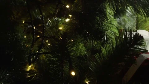 Presents are placed around the bottom of the Christmas tree. Slow motion. HD Stock Footage 83531685