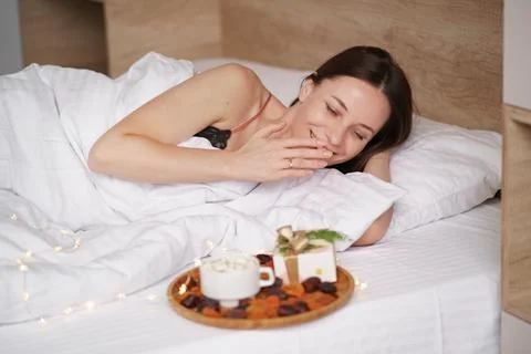 Presents, coffee and sweet awaking woman Stock Photos