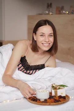 Presents, coffee and sweet awaking woman Stock Photos