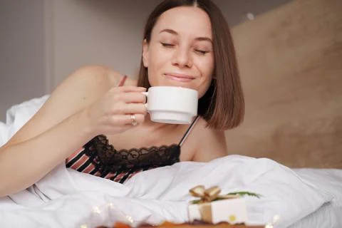 Presents, coffee and sweet awaking woman Stock Photos