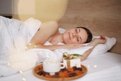 Presents, coffee and sweet sleeping woman Foto stock