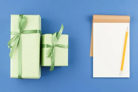 Presents in colored paper with an open notebook. Stock-Fotos
