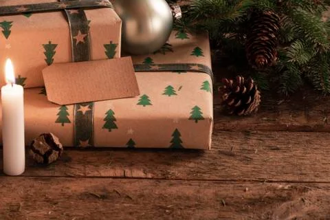 Presents with an empty tag at candlelight Stock Photos