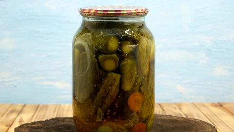 Preservations, conservation Salted pickled cucumbers in a jar on an wooden table Stock Footage 204146778