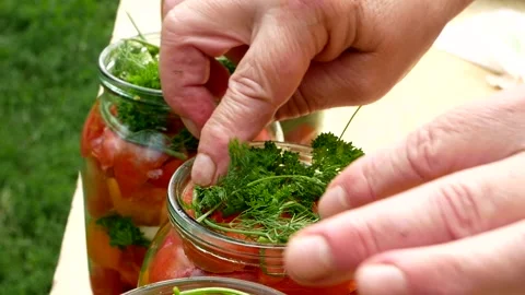 Preservations, conservation Salted pickled tomatoes in a jars on an wooden table Stock Footage 246078688