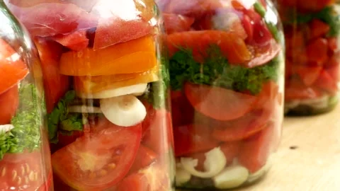 Preservations, conservation Salted pickled tomatoes in a jars on an wooden table Stock Footage 246078793