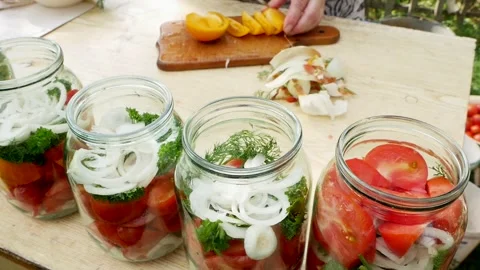 Preservations, conservation Salted pickled tomatoes in a jars on an wooden table Stock Footage 247559327