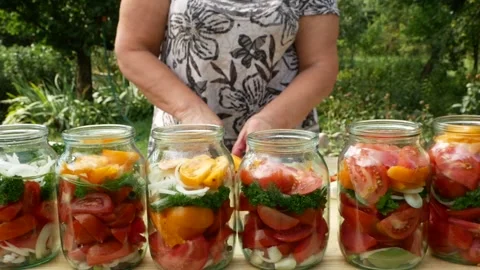 Preservations, conservation Salted pickled tomatoes in a jars on an wooden table Stock Footage 248300747