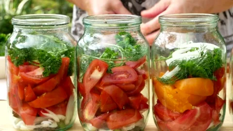 Preservations, conservation Salted pickled tomatoes in a jars on an wooden table Stock Footage 248300806