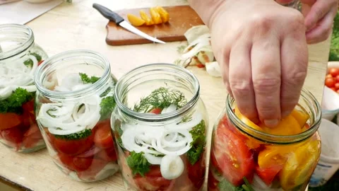 Preservations, conservation Salted pickled tomatoes in a jars on an wooden table Stock Footage 248300901