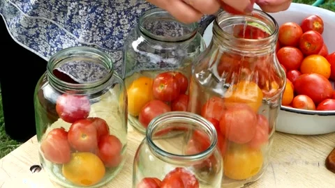 Preservations, conservation Salted pickled tomatoes in a jars on an wooden table Stock Footage 248300965