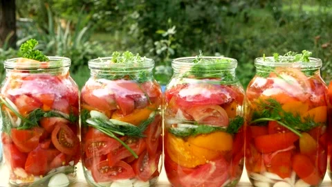 Preservations, conservation Salted pickled tomatoes in a jars on an wooden table Stock Footage 249282053