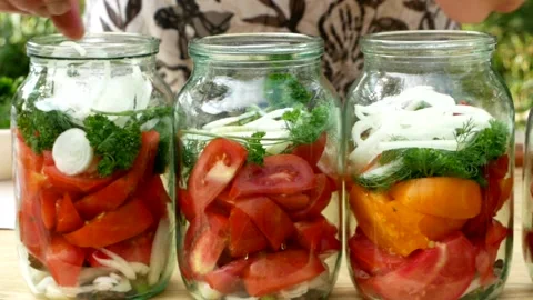 Preservations, conservation Salted pickled tomatoes in a jars on an wooden table Stock Footage 250068713