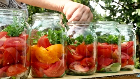 Preservations, conservation Salted pickled tomatoes in a jars on an wooden table Stock Footage 250068811