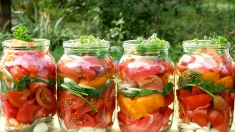 Preservations, conservation Salted pickled tomatoes in a jars on an wooden table Stock Footage 250873920