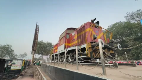 Preserved train engine displayed on raised platform outside Satna railway Stock Footage 327465724