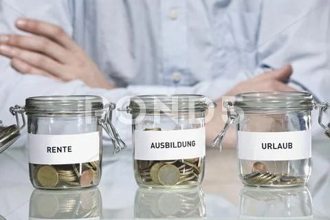 Preserving jars with Euro coins, Person in background Stock Photos