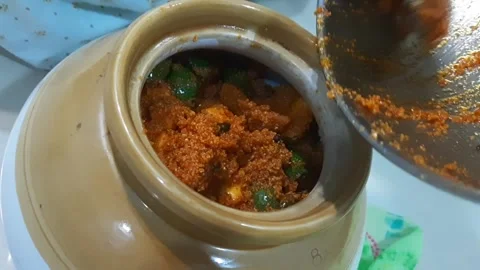 Preserving Mango Pickle by Transferring into Jar - Final Step Stock Footage 337822095