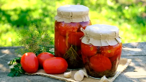 Preserving tomatoes in a jar. Selective focus. Stock Footage 294889999
