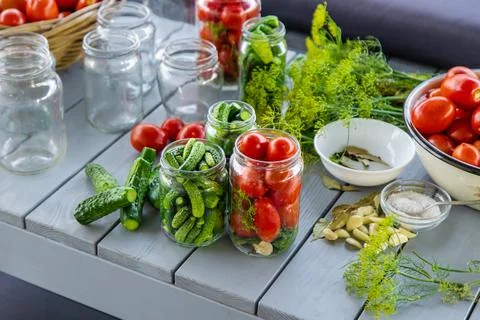 Preserving tomatoes in jars. Selective focus. Stock Photos