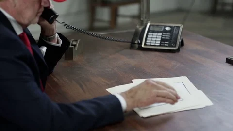 President on the phone while reading documents in oval office Stock Footage 72787210