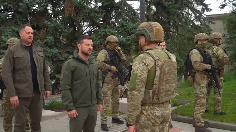 President of Ukraine Volodymyr Zelensky greets military commander in the newly Stock Footage
