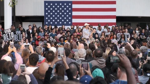 Presidential Candidate Beto Speaks at a Rally Under a Large US Flag Banner Stock Footage