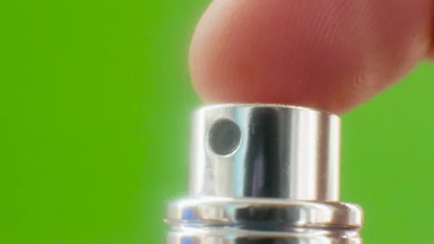 Press Atomizer, Perfume Button. Aroma spray, Eau de toilette on a green Stock Footage 249328054