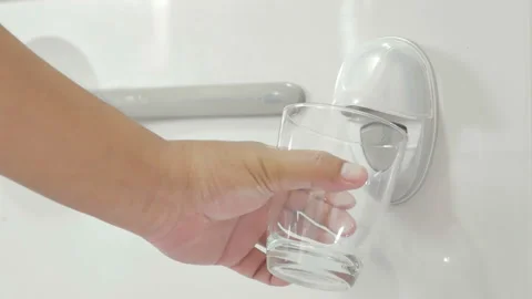 Press the button to drink water at the refrigerator. Video stock 155054356