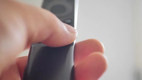 Press the on off button on the remote control Stock Footage 256445450