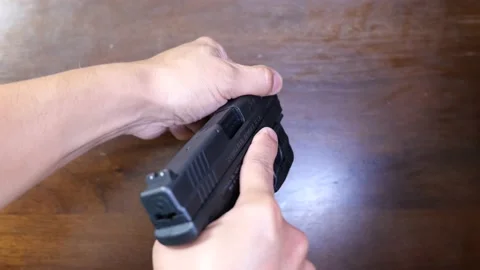 Press check and then dry firing a pistol Stock Footage 196201614