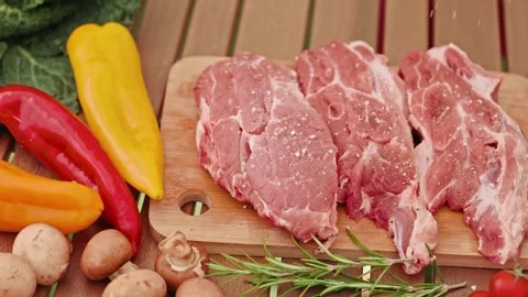 The press chef jumps over raw pork and beef with vegetables on a wooden cutting 스톡 동영상 269035024
