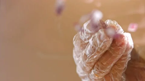 Press the chopped red onion over the hot dog. Bottom filming through the glass Stock Footage 164857769