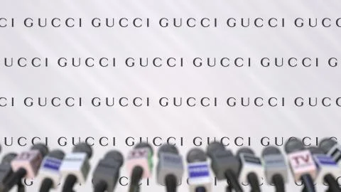 Press conference of GUCCI, press wall with logo and microphones, conceptual Stock Illustration
