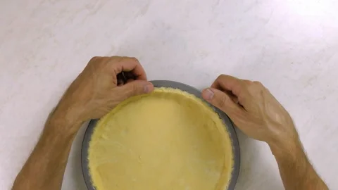 Press dough sheet into baking tin Stock Footage 100195735