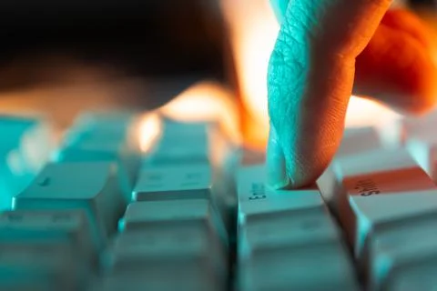 Press enter button on a keyboard with orange and teal light Stock Photos