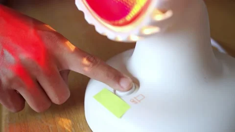 Press the infrared therapy light button Stock Footage 322116075