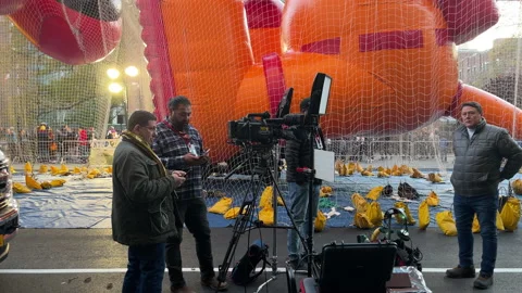 Press mingle around balloons at staging area - Macy's Thanksgiving Day Parade Stock Footage 230467558