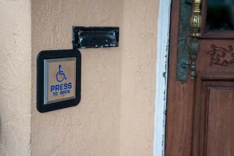 Press to open handicap button disability accessibility outside of door entrance Stock Photos