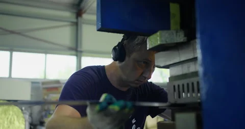 Press operator working in metalworking factory with industrial machine Stock Footage 336302032