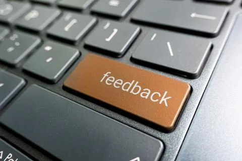 Press orange feedback button on laptop keyboard. feedback inscriptions on the Stock Photos