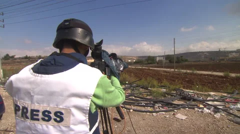 A press photographer during clashes between Palestinians and the Israeli army  Video stock 65075860