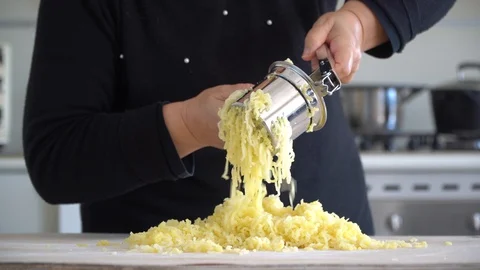 Press potatoes doing gnocchi pasta Stockbeeldmateriaal 128987674