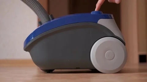 Press push the button and turn on the vacuum cleaner. Cleaning of the apartment Stock Footage 141710079