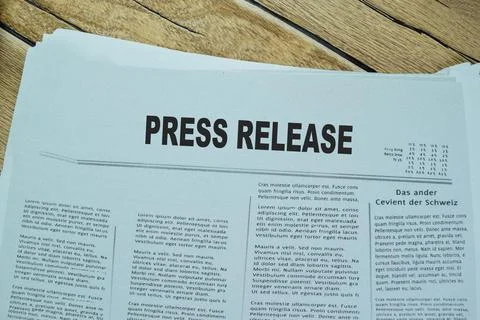 Press Release text in headline isolated on wooden table. Stock Photos