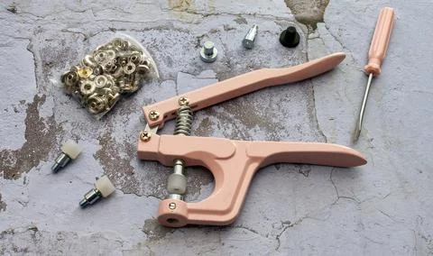 Press stud set with pliers. Set for punching holes or attaching press studs. Stock Photos