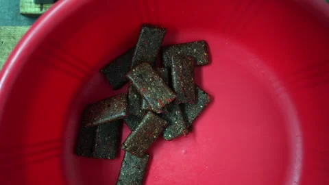 Pressed date energy bars drop into bin from food production line Stock Footage 305134621